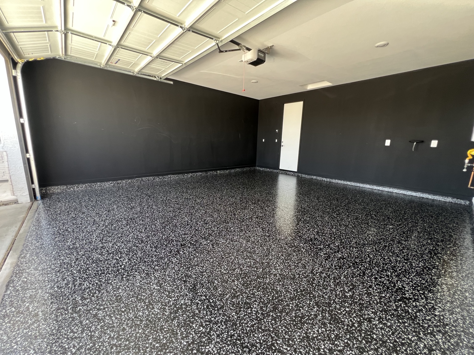 Finished black and white flake garage floor